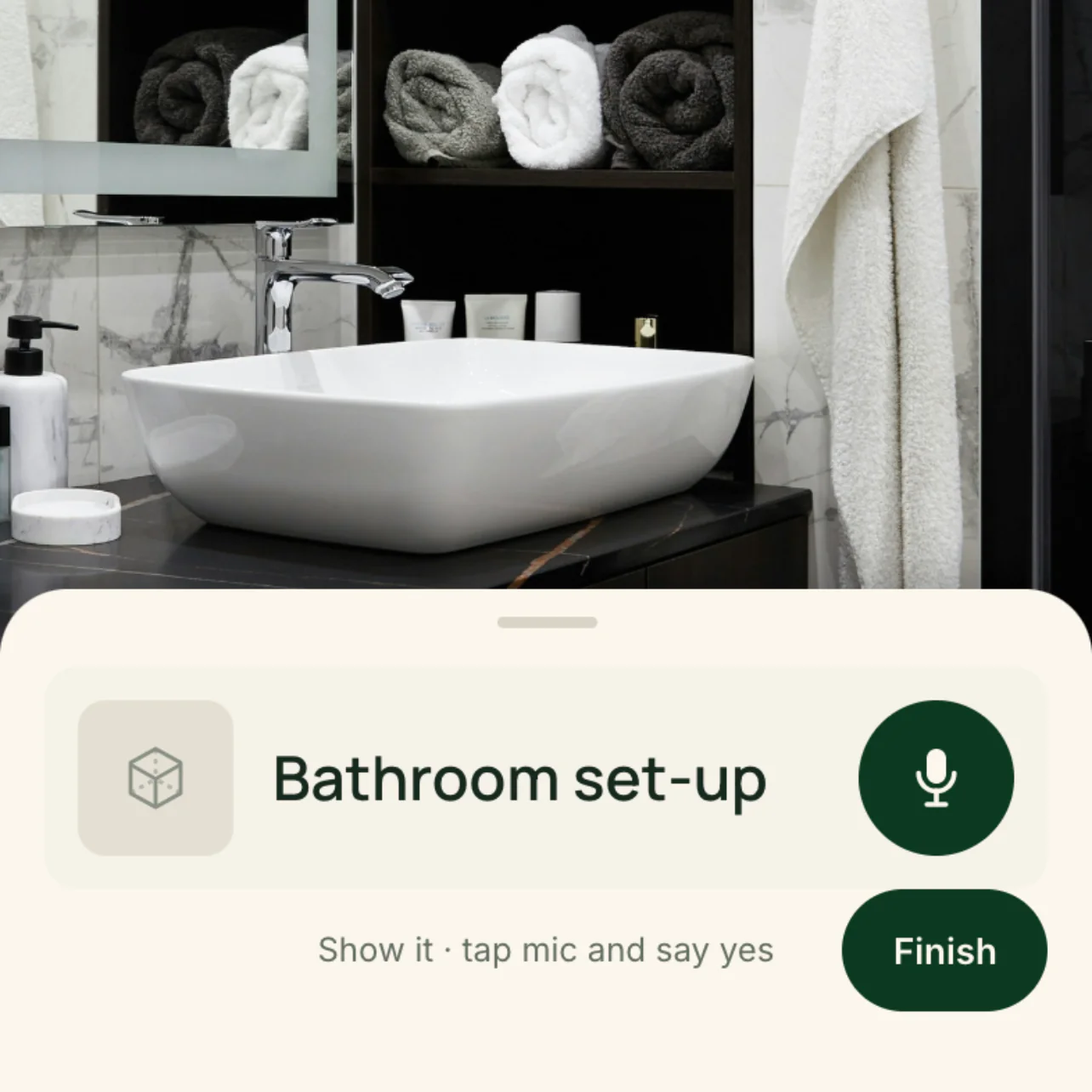 The Levee app mid-check in Room 412: the camera view of the bathroom vanity, with rolled towels on the shelf, the basin, the amenity line and a hanging hand towel, under the checklist card for the bathroom set-up, its mic button, the caption 'Show it · tap mic and say yes' and the Finish button.